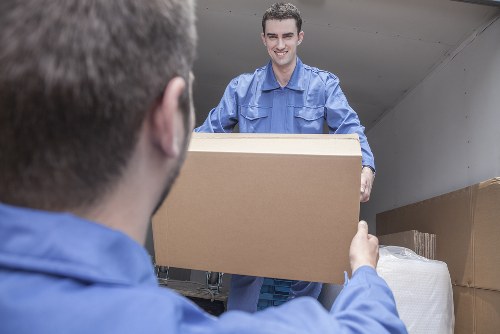 Removal van and moving team working on a busy Shoreditch street