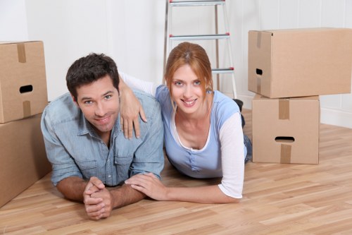 Van removal team handling boxes and furniture for a flat move in Shoreditch